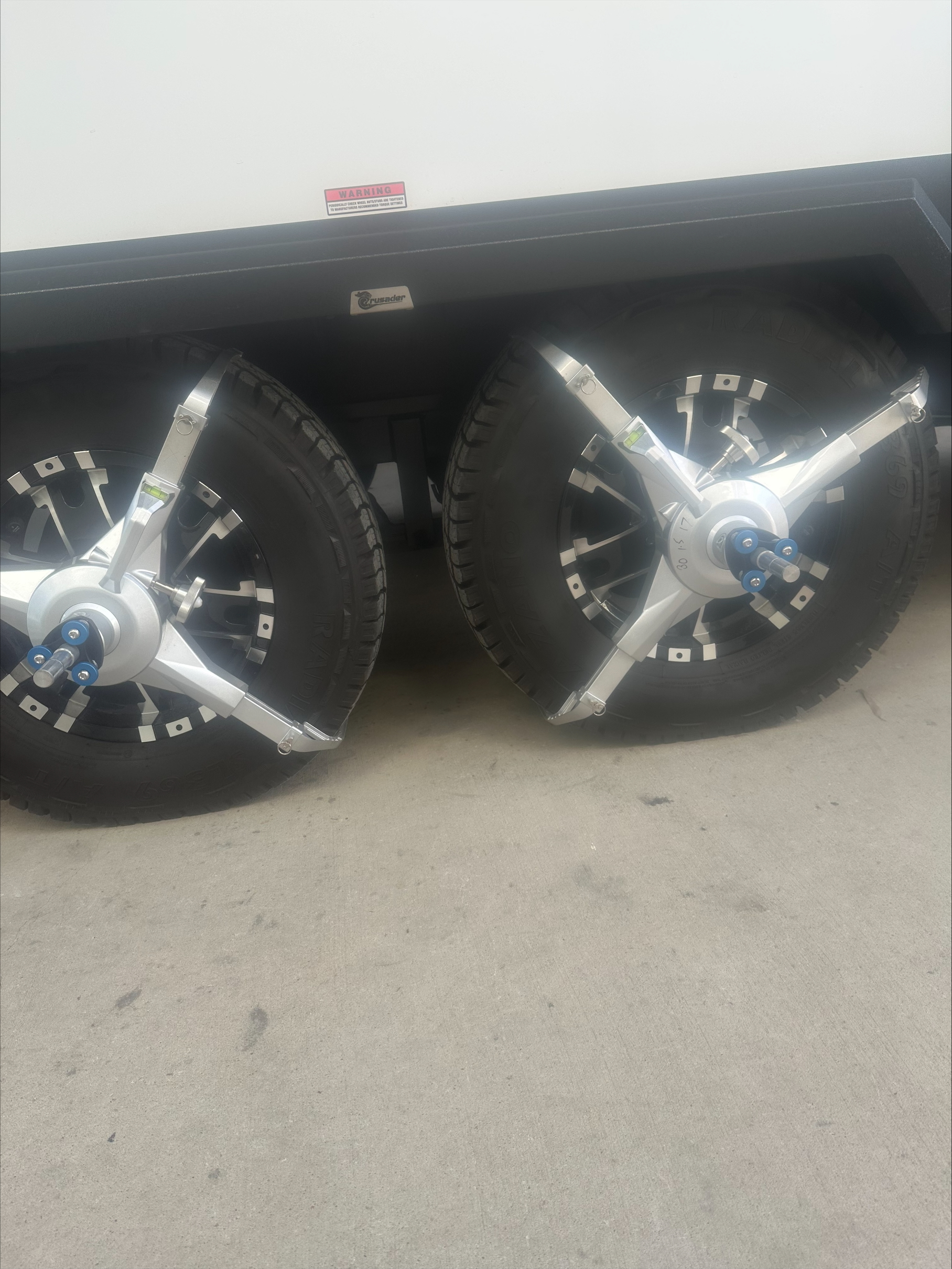 Caravan wheel alignment frames with run-out compensation